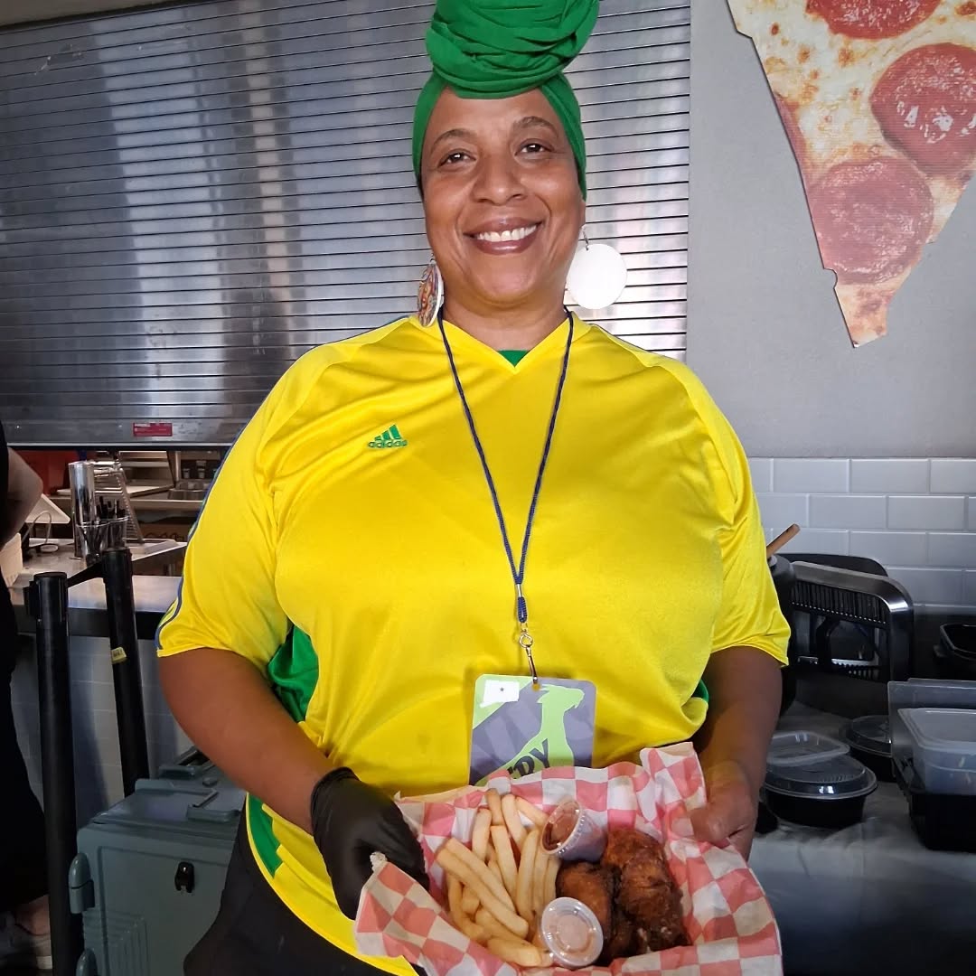 Chef Izolda Miranda serving food at a catered event