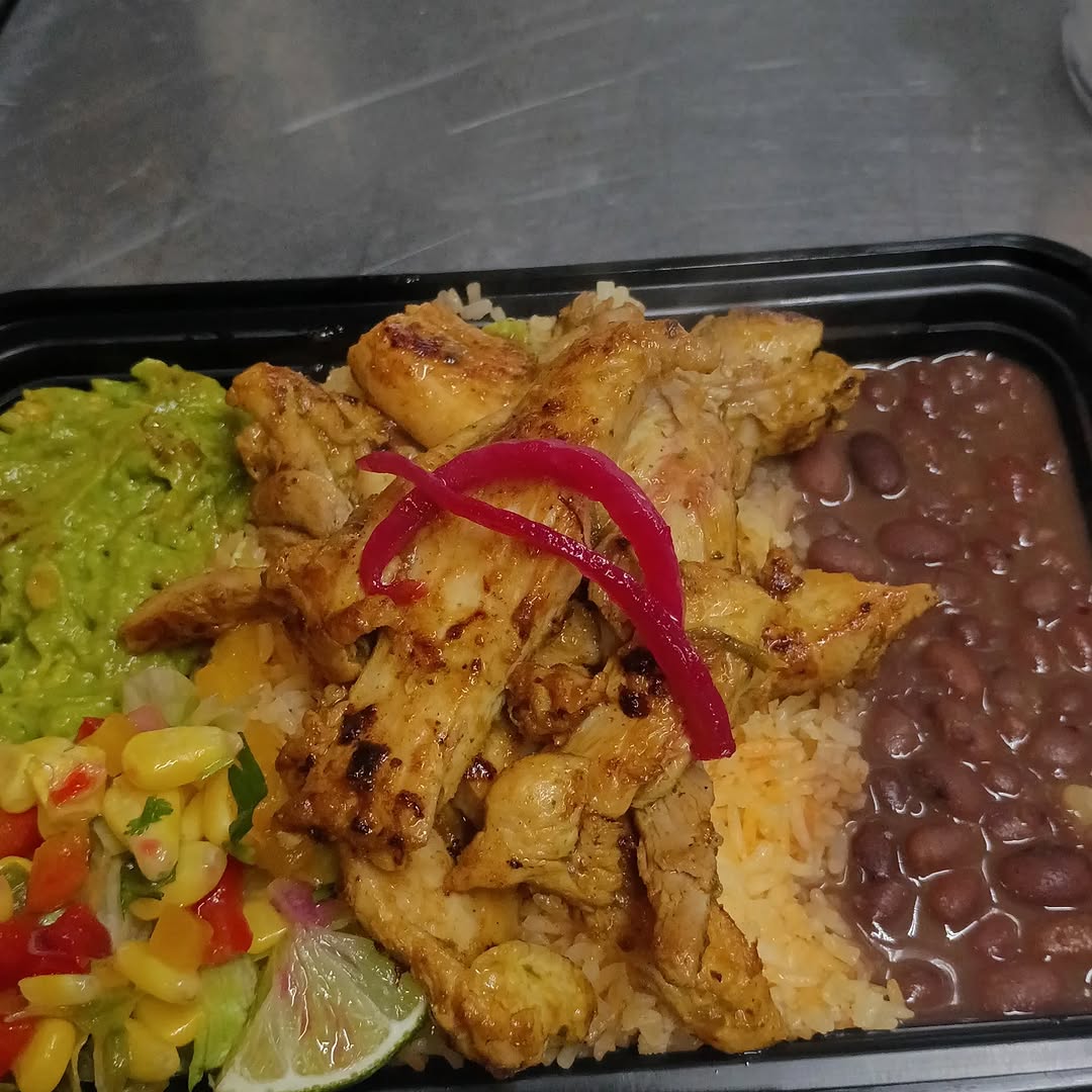Grilled chicken bowl with rice, beans, corn salsa, and guacamole